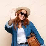 redhead traveler girl with suitcase saluting with crca6333281 size20.37mb 6234x4158 - title:Home - اورچین فایل - format: - sku: - keywords:وکتور,موکاپ,افکت متنی,پروژه افترافکت p_id:63922