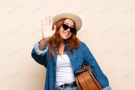 redhead traveler girl with suitcase saluting with crca6333281 size20.37mb 6234x4158 - title:Home - اورچین فایل - format: - sku: - keywords:وکتور,موکاپ,افکت متنی,پروژه افترافکت p_id:63922