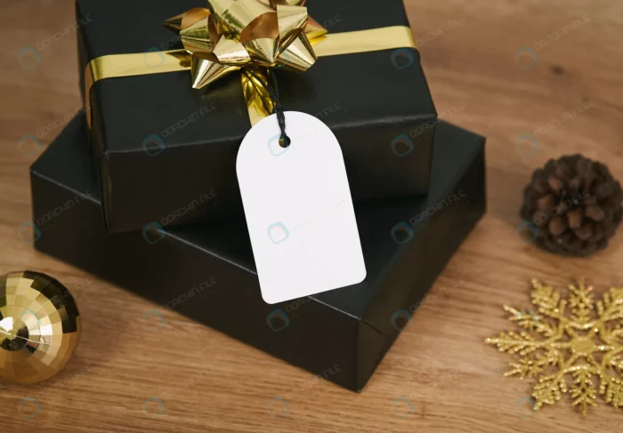 black gift box mockup christmas greeting tags woo crc905e94ae - title:تصویر هدیه با کاغذ کادو مشکی و روبان طلایی - اورچین فایل - format:JPG - استوک - sku:crc905e94ae - keywords: p_id:54432