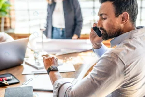 businessman checking his smartwatch while talking rnd339 frp26980946 - title:Home - اورچین فایل - format: - sku: - keywords: p_id:18