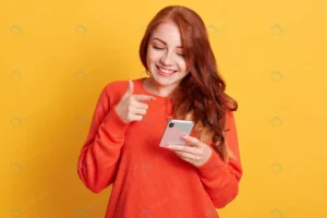 cheerful woman pointing her smart phone screen wi crcea4ff1b3 size8.88mb 5760x3840 - title:Home - اورچین فایل - format: - sku: - keywords: p_id:18