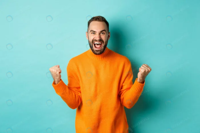 excited man celebrating victory rejoicing making crcf7188e45 size10.00mb 6000x4000 1 - title:استوک مرد خوشحال با لباس نارنجی - اورچین فایل - format:JPG - استوک - sku:crcf7188e45 - keywords: p_id:49021