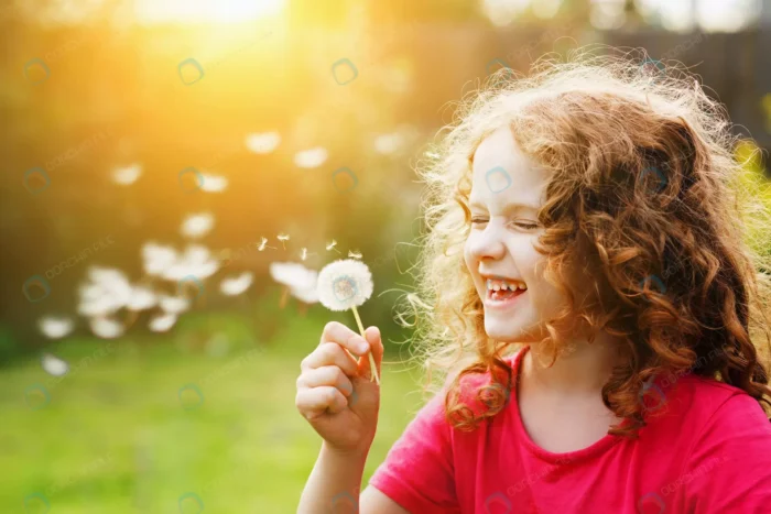 little curly girl blowing dandelion laughing crc89c8d188 - title:دختر خندان با گل قاصدک - اورچین فایل - format:JPG - استوک - sku:crc89c8d188 - keywords: p_id:84357