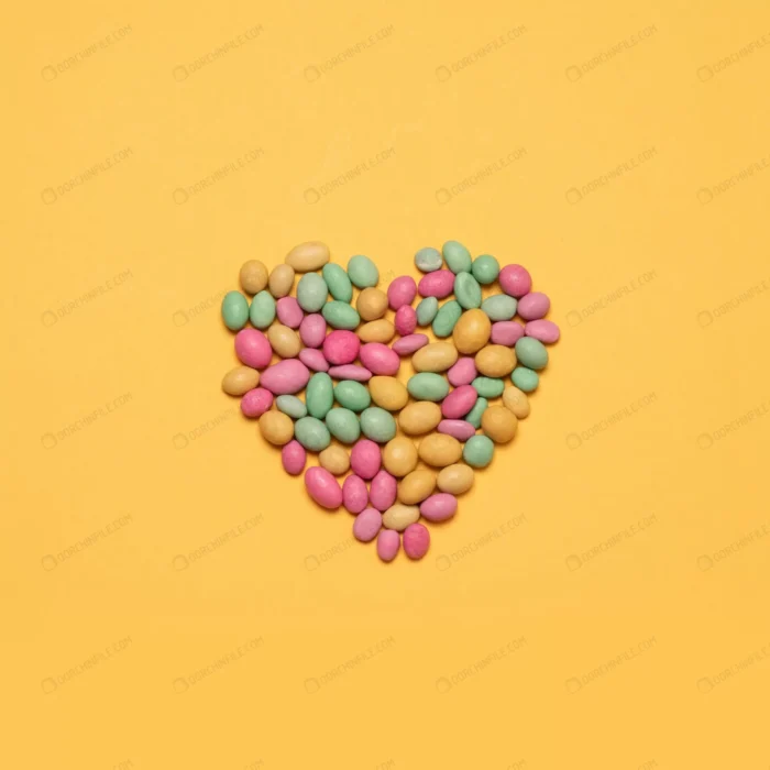 multicolored heart shaped candy yellow background crc0c74d58b - title:طرح قلب از جنس اسمارتیز - اورچین فایل - format:JPG - استوک - sku:crc0c74d58b - keywords: p_id:100003