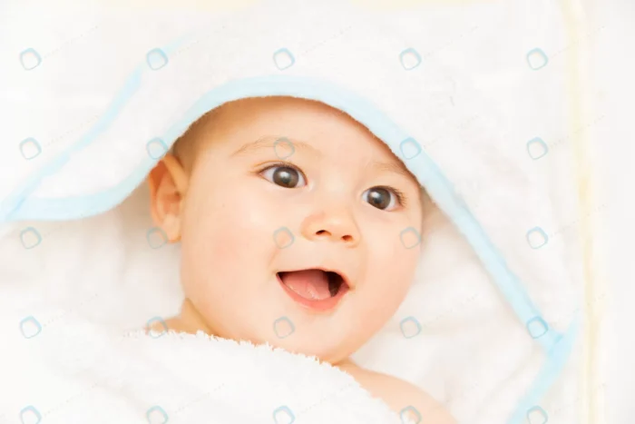 newborn boy relaxing bed after bath shower newbor crc66a67f68 - title:تصویر استوک کلوزآپ نوزاد با حوله - اورچین فایل - format:JPG - استوک - sku:crc66a67f68 - keywords: p_id:64396