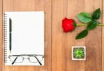 red roses wooden table notepad - title:Home Main - اورچین فایل - format: - sku: - keywords: p_id:18