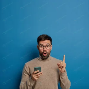 surprised unshaven man holds phone shows empty sp crcd47e7704 size18.29mb 8495x8495 - title:Home - اورچین فایل - format: - sku: - keywords: p_id:18