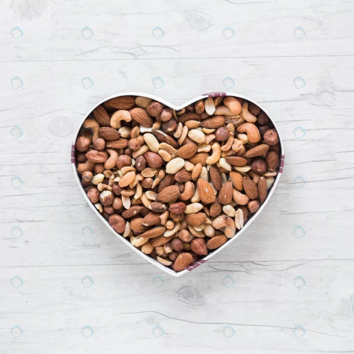 top view healthy dryfruits heart shape wooden des crcaa03eda6 - title:عکس آجیل داخل ظرف از نمای تاپ - اورچین فایل - format:JPG - استوک - sku:crcaa03eda6 - keywords: p_id:58941