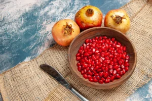 top view pomegranate seeds wooden bowl dinner kni crcc2e2d514 size16.97mb 5600x3733 - title:Home - اورچین فایل - format: - sku: - keywords: p_id:18