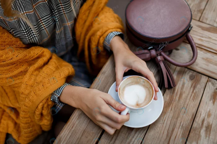 woman drinking coffee stylish bag table wearing g crcfde60e65 - title:فنجان قهوه و کیف روی میز چوبی - اورچین فایل - format:JPG - استوک - sku:crcfde60e65 - keywords: p_id:77911