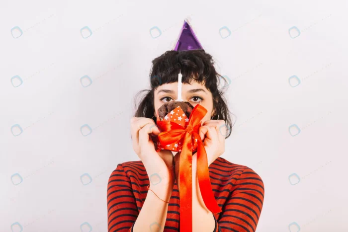 woman holding cake front her face with ribbon can crc0a3d5844 - title:تصویر استوک تولد با طرح دختر فانتزی - اورچین فایل - format:JPG - استوک - sku:crc0a3d5844 - keywords: p_id:46489