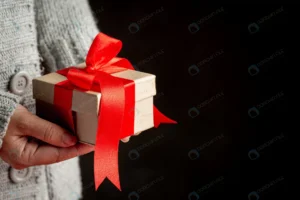 woman s hand holding gift box with red ribbon crc54ca5bd5 size9.12mb 5760x3840 - title:Home - اورچین فایل - format: - sku: - keywords: p_id:18