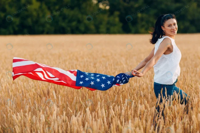 woman with american flag wheat field sunset rnd913 frp9671972 - title:تصویر خانم با پرچم آمریکا در مزرعه گندم - اورچین فایل - format:JPG - استوک - sku:frp9671972 - keywords: p_id:73921