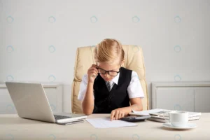 young blond caucasian boy sitting executive desk crcb0633920 size11.41mb 7360x4912 1 - title:Home - اورچین فایل - format: - sku: - keywords: p_id:18