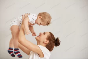 young mother playing with her little baby bed crc43dfc17d size6.42mb 5760x3840 - title:Home - اورچین فایل - format: - sku: - keywords: p_id:18